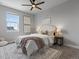 Cozy bedroom with neutral tones, large windows, and a decorative rug at 5399 Valentia St, Denver, CO 80238