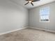 Bedroom with plush carpet and a large window at 5399 Valentia St, Denver, CO 80238