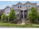 Charming townhome with gray siding, front steps and manicured landscaping at 5399 Valentia St, Denver, CO 80238