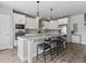 Modern kitchen with white cabinets, granite countertops, and stainless steel appliances at 5399 Valentia St, Denver, CO 80238
