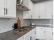 Close-up of a modern kitchen with gas cooktop and subway tile backsplash at 5399 Valentia St, Denver, CO 80238