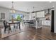 Open-concept kitchen with island, dining table, and modern appliances at 5399 Valentia St, Denver, CO 80238
