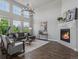 Spacious living room with fireplace, modern lighting, and hardwood floors at 5399 Valentia St, Denver, CO 80238