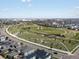 Aerial view of neighborhood park and green space with residential area in the distance at 5399 Valentia St, Denver, CO 80238