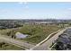 Aerial view of neighborhood green space with ponds and distant city views at 5399 Valentia St, Denver, CO 80238