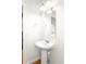 Bright, clean half bathroom with a modern pedestal sink and mirror at 23293 E Jamison Dr, Aurora, CO 80016
