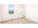 Bright bedroom featuring a window with neighborhood views, and a door into the hallway at 23293 E Jamison Dr, Aurora, CO 80016