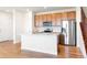 Stylish kitchen with island, stainless appliances, and ample cabinet space at 23293 E Jamison Dr, Aurora, CO 80016