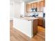 Kitchen island with modern stainless appliances and wood cabinetry at 23293 E Jamison Dr, Aurora, CO 80016