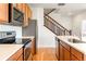 Close-up of kitchen with stainless appliances, backsplash, and hardwood floors at 23293 E Jamison Dr, Aurora, CO 80016