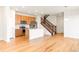 Open kitchen with stainless steel appliances, a kitchen island and hardwood floors at 23293 E Jamison Dr, Aurora, CO 80016
