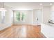 Bright living space with hardwood floors and large windows, adjacent to kitchen at 23293 E Jamison Dr, Aurora, CO 80016
