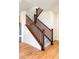 Carpeted staircase with wood railing leading to the upper level at 23293 E Jamison Dr, Aurora, CO 80016