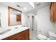 Clean bathroom featuring a vanity with wood cabinets, white sink, and a large mirror at 1757 S Elm St, Denver, CO 80222