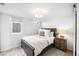 Comfortable bedroom with a dark wood bed frame, neutral bedding, and soft lighting at 1757 S Elm St, Denver, CO 80222