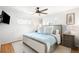 Bright bedroom featuring a ceiling fan, plush bedding, and natural light from two windows at 1757 S Elm St, Denver, CO 80222