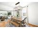 Bright dining room features hardwood floors, modern lighting, and a rustic wood table and bench seating at 1757 S Elm St, Denver, CO 80222