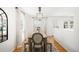 Bright dining area with wood floors, modern lighting, and a rustic table with bench seating at 1757 S Elm St, Denver, CO 80222