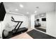 Home gym featuring a treadmill, mirrored wall, and black exercise mats at 1757 S Elm St, Denver, CO 80222
