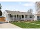 Charming home with a welcoming front porch and well-manicured lawn at 1757 S Elm St, Denver, CO 80222