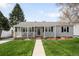 Charming single-story home with well-manicured lawn, inviting porch, and freshly painted light gray exterior at 1757 S Elm St, Denver, CO 80222