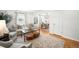 Inviting living room featuring hardwood floors, comfortable seating, and seamless transition to the dining area at 1757 S Elm St, Denver, CO 80222