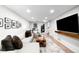 Cozy living room featuring a sectional sofa, hardwood floors, and stylish wall decor at 1757 S Elm St, Denver, CO 80222
