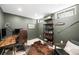 Home office with a desk, shelving, and a leather chair, offering a functional workspace at 1757 S Elm St, Denver, CO 80222