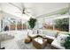 Spacious sunroom with tile flooring, comfortable wicker seating, and abundant natural light with backyard views at 1757 S Elm St, Denver, CO 80222