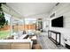 Bright sunroom with tile floors, comfortable seating, and walls of windows providing backyard views at 1757 S Elm St, Denver, CO 80222