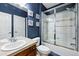Well-appointed bathroom with a glass shower enclosure, vanity, and blue walls at 4915 Sage Brush Dr, Broomfield, CO 80023