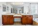 Elegant bathroom featuring dual vanity with wood cabinets and a large mirror at 4915 Sage Brush Dr, Broomfield, CO 80023