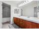 Bright bathroom featuring dual sinks and a walk-in shower at 4915 Sage Brush Dr, Broomfield, CO 80023