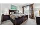 Comfortable bedroom featuring dark wood furniture and decorative window treatments at 4915 Sage Brush Dr, Broomfield, CO 80023