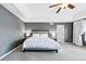Spacious main bedroom with a tray ceiling, gray walls, and bright white bedding and curtains at 4915 Sage Brush Dr, Broomfield, CO 80023