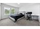 Bedroom featuring dual windows, a grey bed, and a dedicated workspace at 4915 Sage Brush Dr, Broomfield, CO 80023