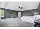 Spacious main bedroom with a tray ceiling, gray walls, and gray dresser with mirror at 4915 Sage Brush Dr, Broomfield, CO 80023