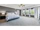 Spacious main bedroom with a tray ceiling, gray walls, and bright white accents from bedding and curtains at 4915 Sage Brush Dr, Broomfield, CO 80023
