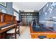Spacious office with a bookshelf, piano, and well-lit desk area at 4915 Sage Brush Dr, Broomfield, CO 80023