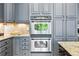 Modern kitchen featuring stainless steel double ovens and beautiful granite countertops at 4915 Sage Brush Dr, Broomfield, CO 80023