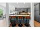 Kitchen island with granite countertops and bar stool seating, gray cabinetry and modern appliances at 4915 Sage Brush Dr, Broomfield, CO 80023