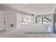 Finished basement with neutral carpet, large windows, and walkout access at 9752 Canyon Wind Pt, Parker, CO 80138