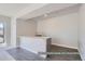 Finished basement with modern bar, sink, and sleek gray tile flooring at 9752 Canyon Wind Pt, Parker, CO 80138