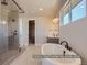Modern bathroom boasts a soaking tub, glass-enclosed shower, and dual sink vanity at 9752 Canyon Wind Pt, Parker, CO 80138