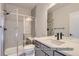 Modern bathroom with glass-enclosed shower, gray tile, and sleek vanity at 9752 Canyon Wind Pt, Parker, CO 80138