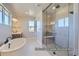 Bright bathroom featuring a soaking tub and modern glass-enclosed shower at 9752 Canyon Wind Pt, Parker, CO 80138