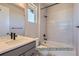 Stylish bathroom with white tiling, dark fixtures, and a shower-tub combo at 9752 Canyon Wind Pt, Parker, CO 80138