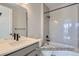 Stylish bathroom with white tiling, dark fixtures, and a shower-tub combo at 9752 Canyon Wind Pt, Parker, CO 80138