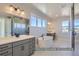 Luxurious bathroom featuring a soaking tub, double vanity, and glass shower at 9752 Canyon Wind Pt, Parker, CO 80138