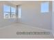 Bright bedroom featuring neutral walls, carpet and large windows with neighborhood views at 9752 Canyon Wind Pt, Parker, CO 80138